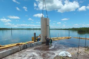 Florida Marine Construction installing commercial concrete seawall slabs in Southwest Florida
