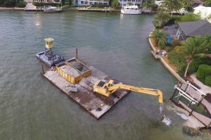 Florida Marine Construction providing dockside dredging for Marco Island client.
