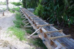 Upland vinyl seawall to increase lot elevation.