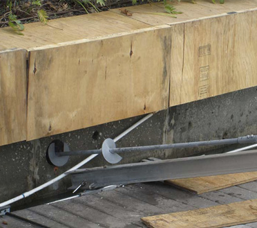 8 inch helical progressing though cored hole in concrete seawall for tie backs